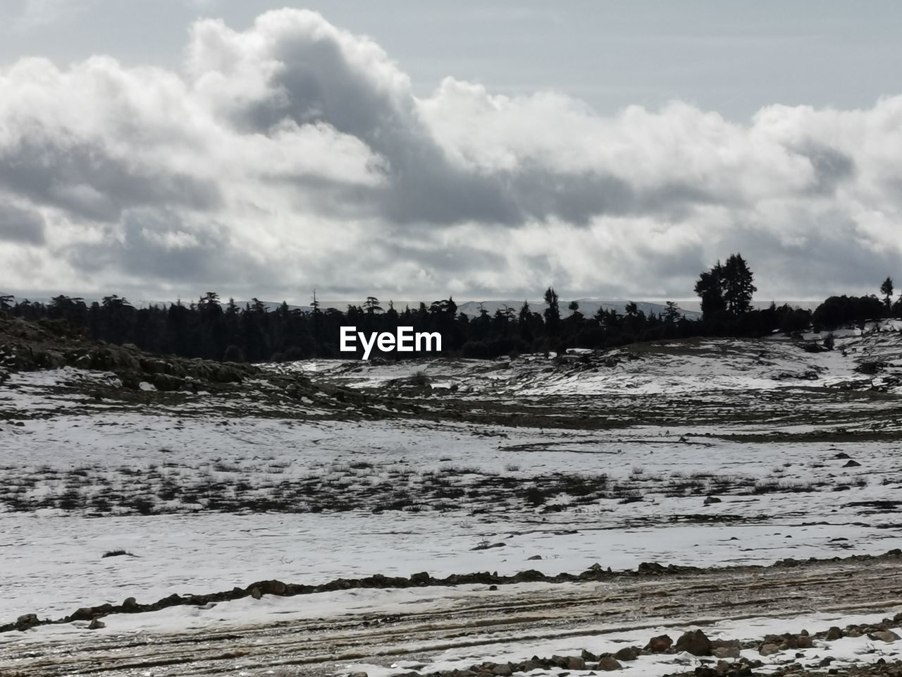 Scenic view of snow covered land against sky