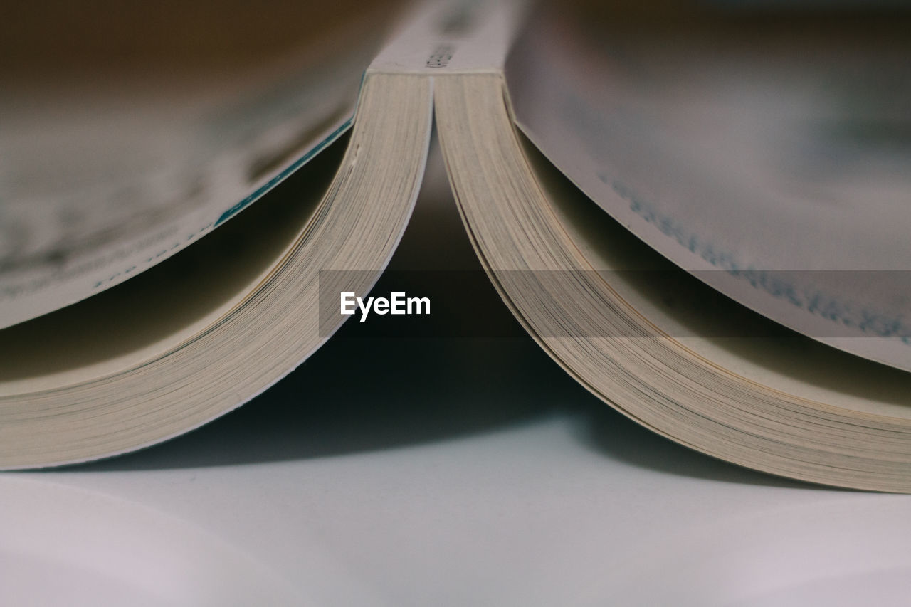 Close-up of upside down open book on table