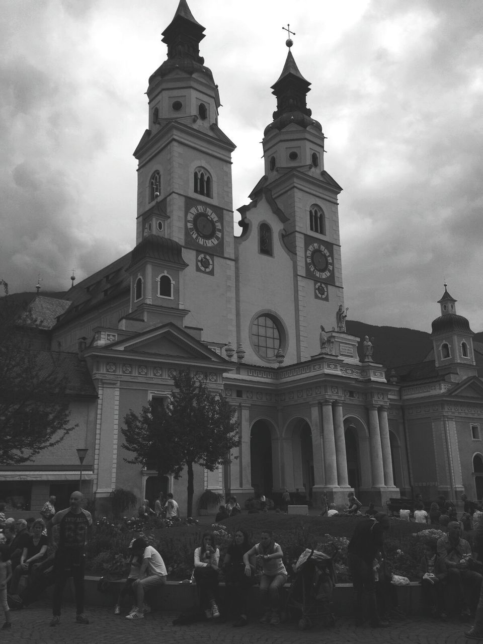 TOURISTS IN FRONT OF CHURCH AGAINST SKY