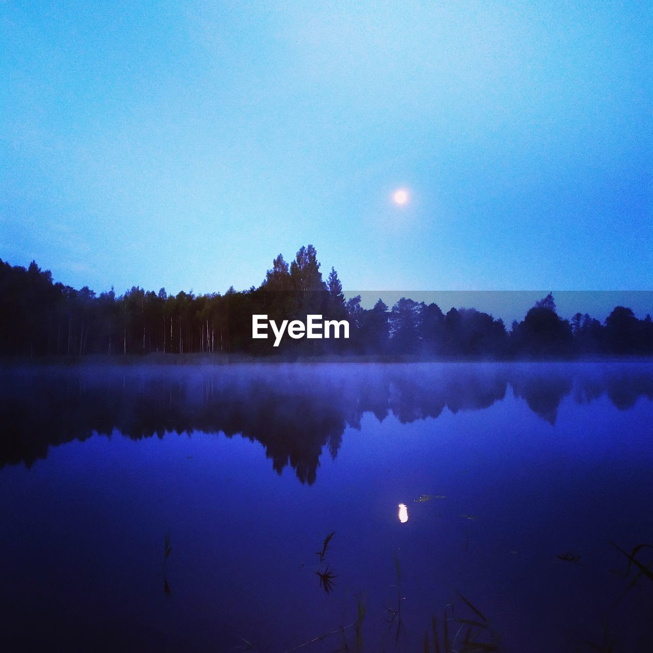 Scenic view of lake against blue sky