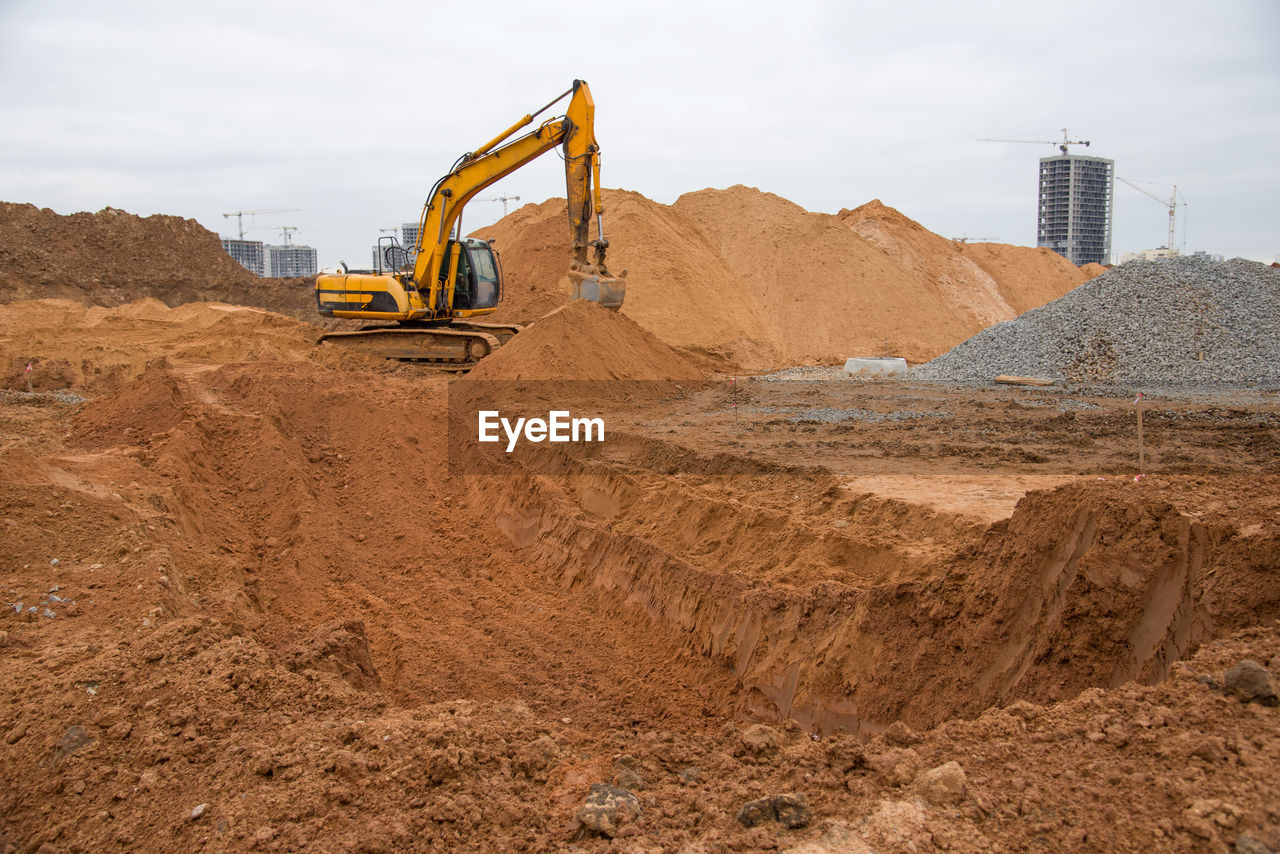 Excavator at earthworks on construction site. backhoe loader digs a pit for the construction 