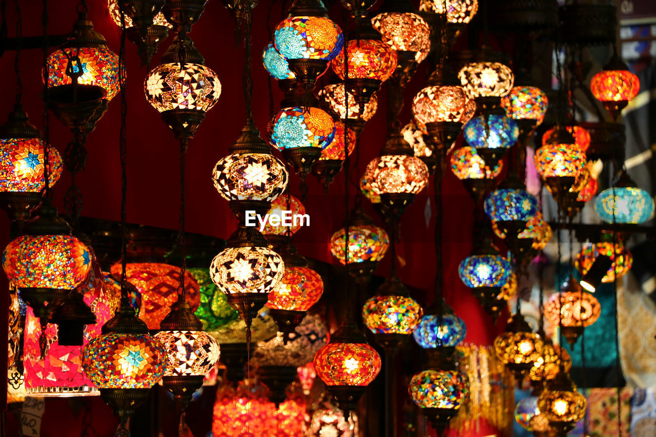 Close-up of illuminated lanterns hanging for sale