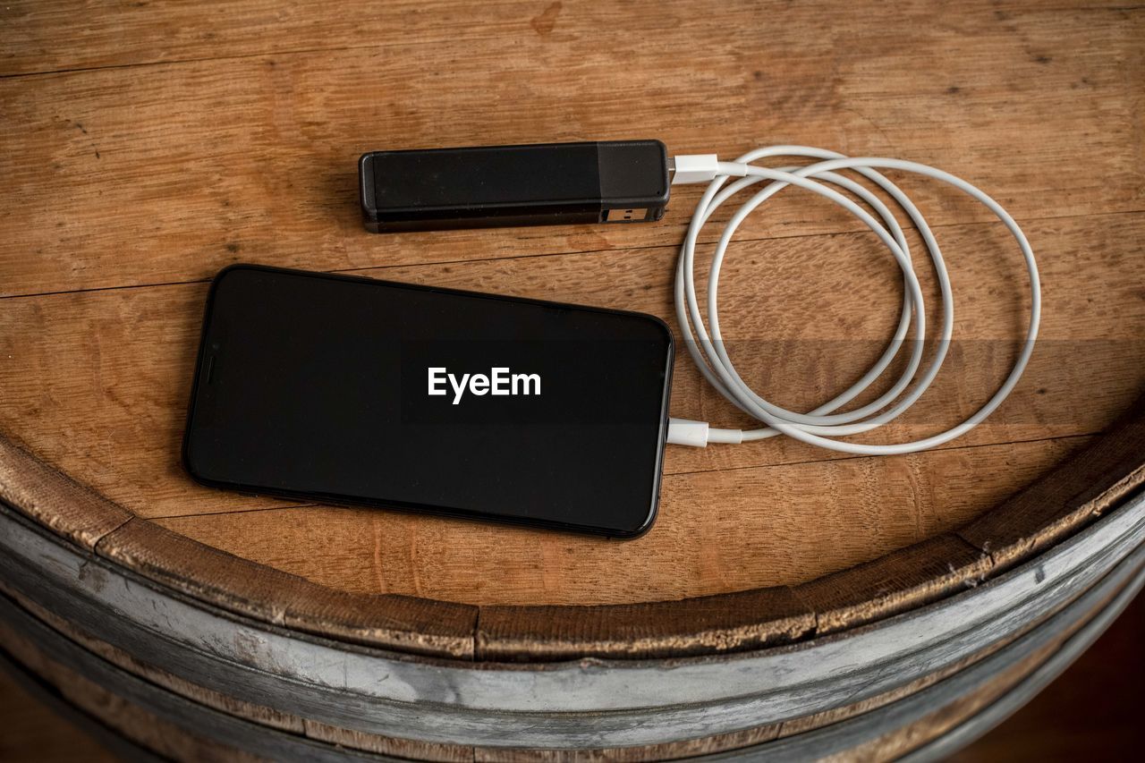 A smartphone charges through a usb battery charger.