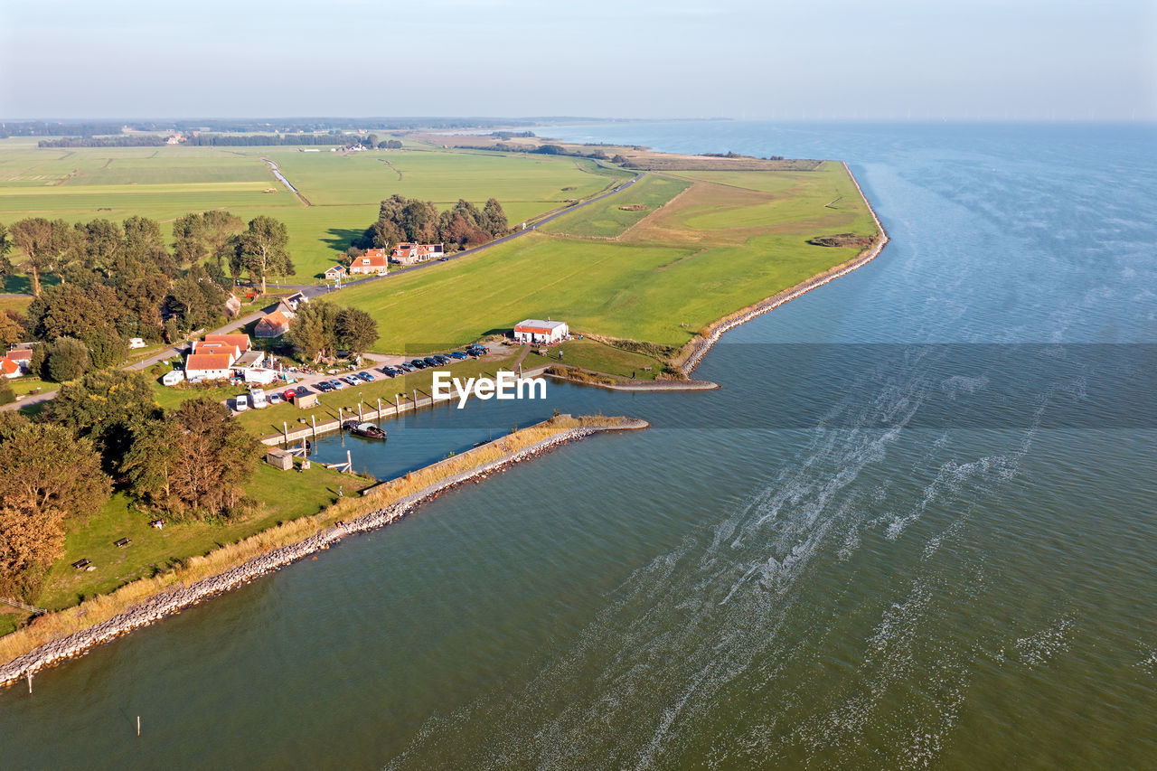 Aerial from the little old village and harbor from laaxum at the ijsselmeer in the netherlands