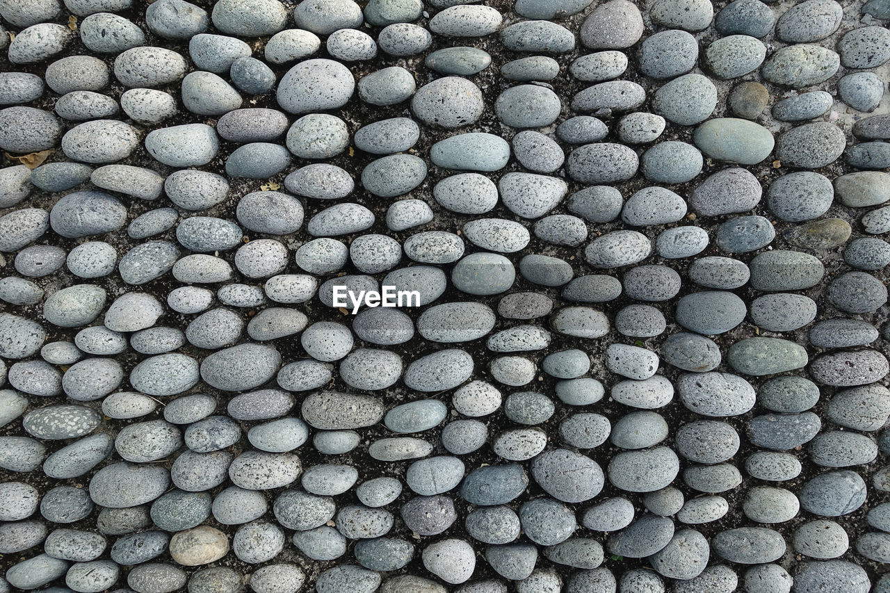 Full frame shot of pebbles arranged on pathway