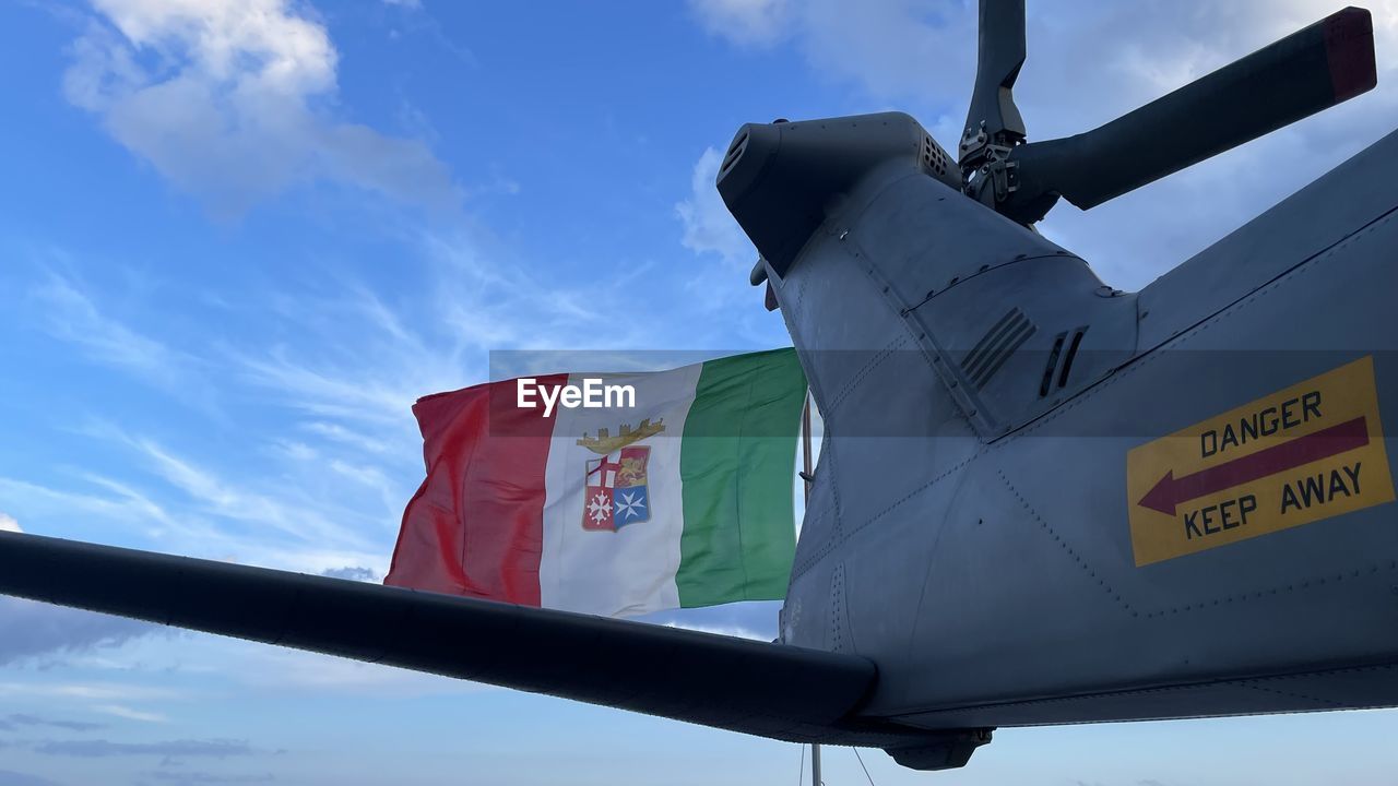 low angle view of airplane against blue sky