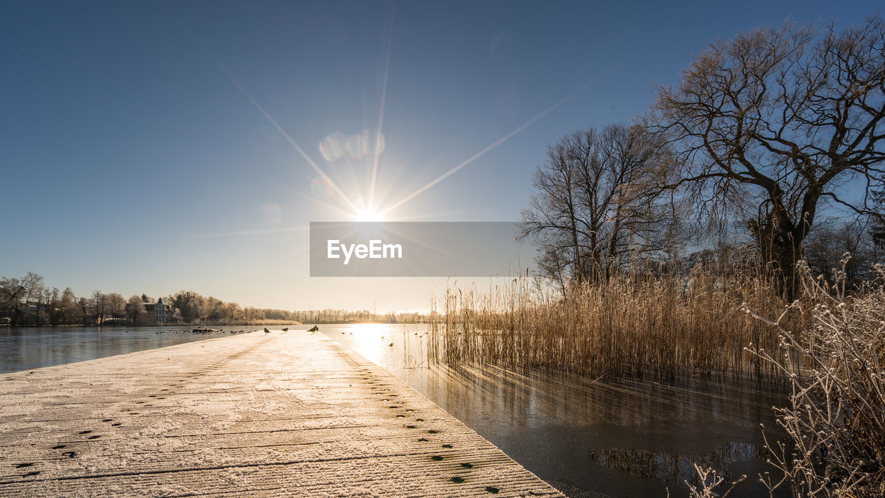 SCENIC VIEW OF LAKE AGAINST BLUE SKY