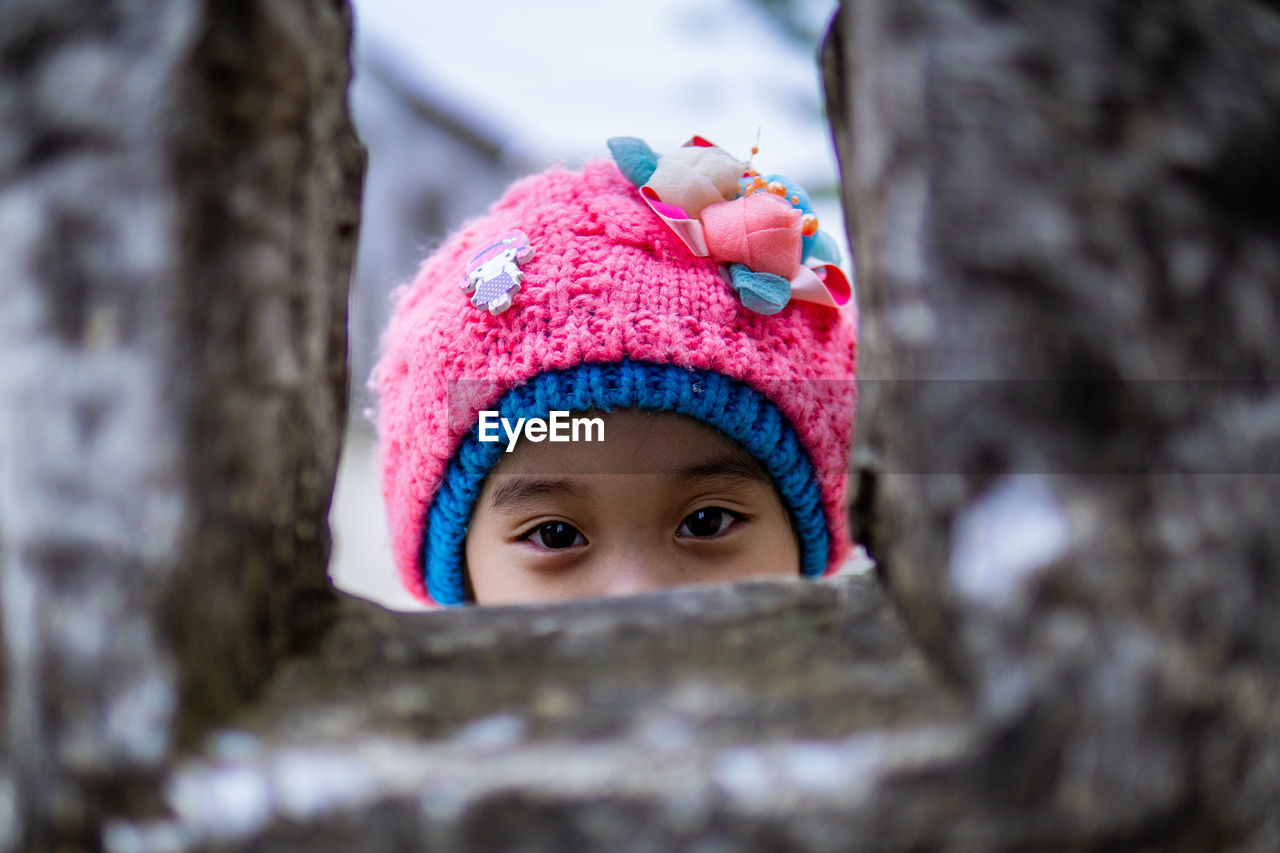 CLOSE-UP PORTRAIT OF A BOY IN SNOW