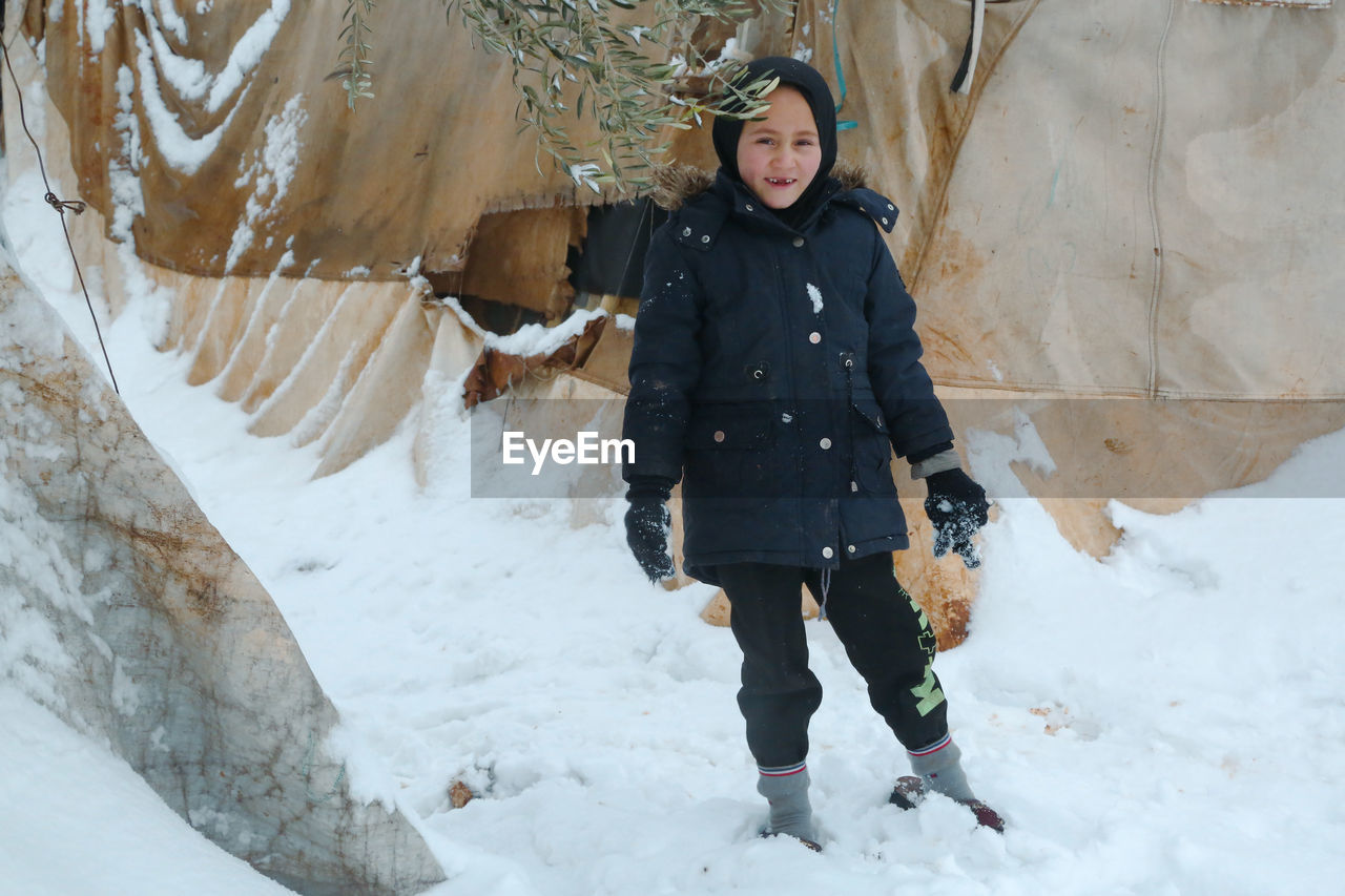 Syrian refugee children playing in the snow that fell on the camp near the syrian-turkish border.