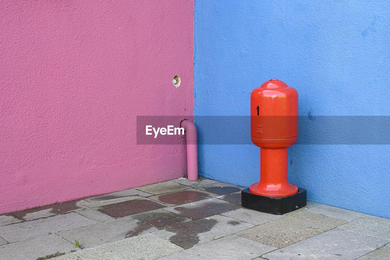 Red fire hydrant on wall