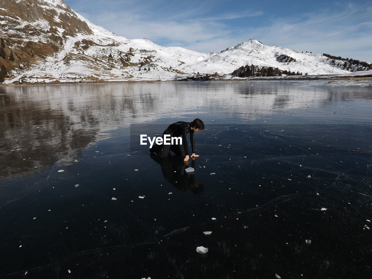 Man standing on lake against sky