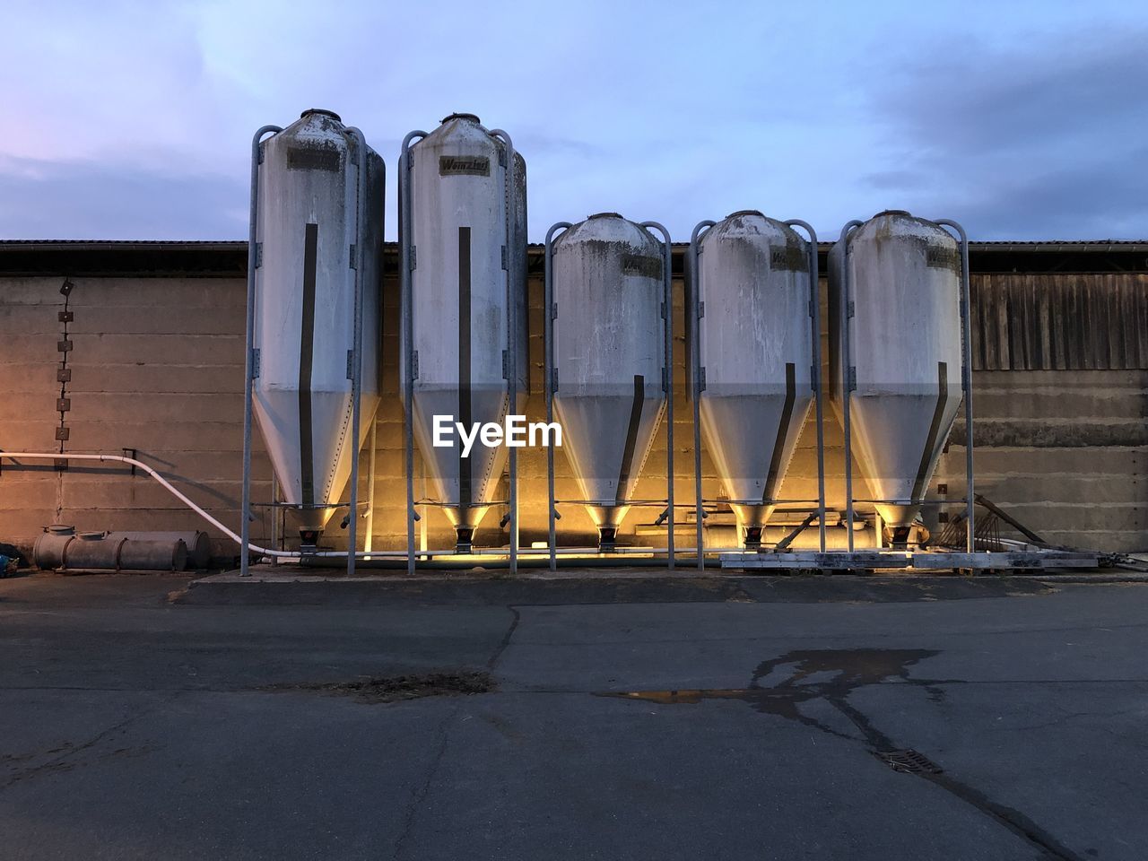 Factory against sky at sunset