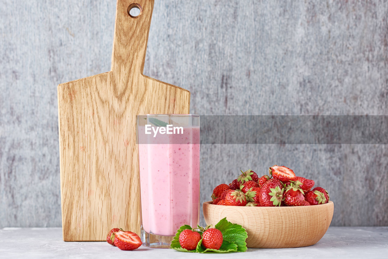 CLOSE-UP OF FRESH FRUITS ON WOODEN TABLE