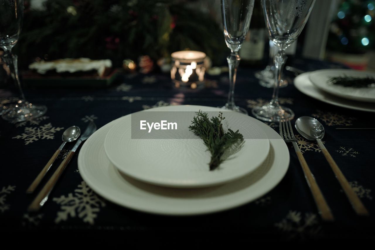 Close-up of plates and glasses on table