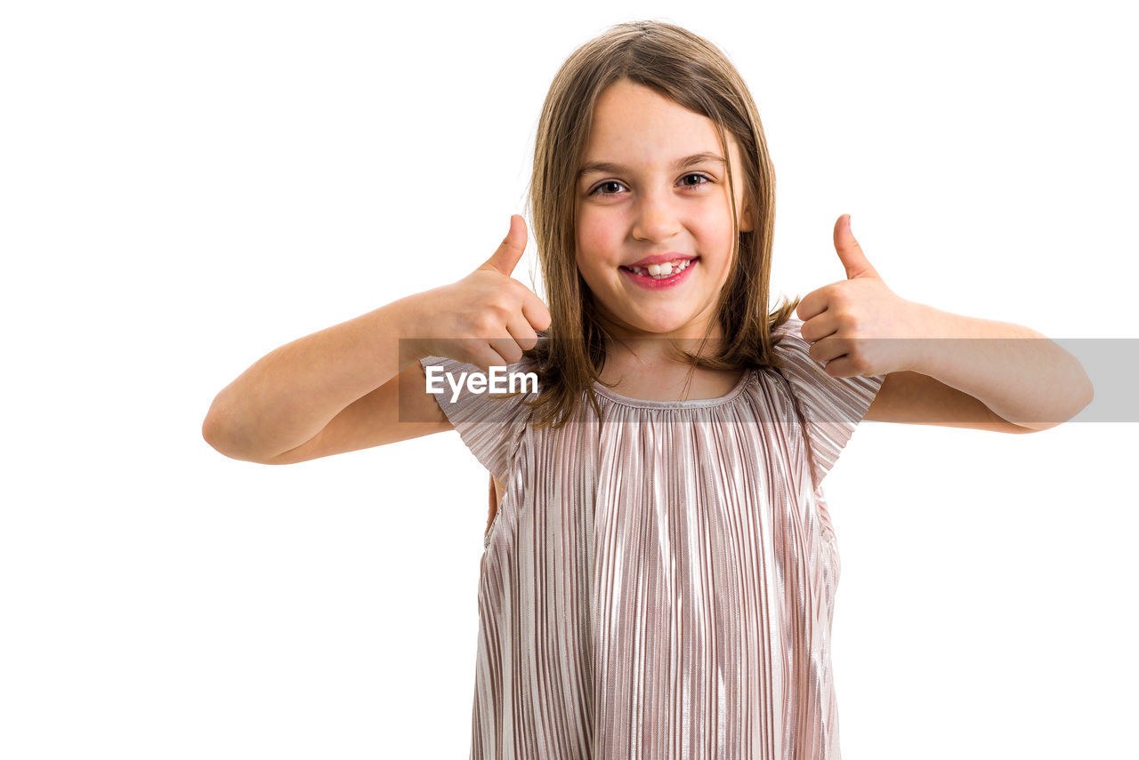 Portrait of smiling girl against white background