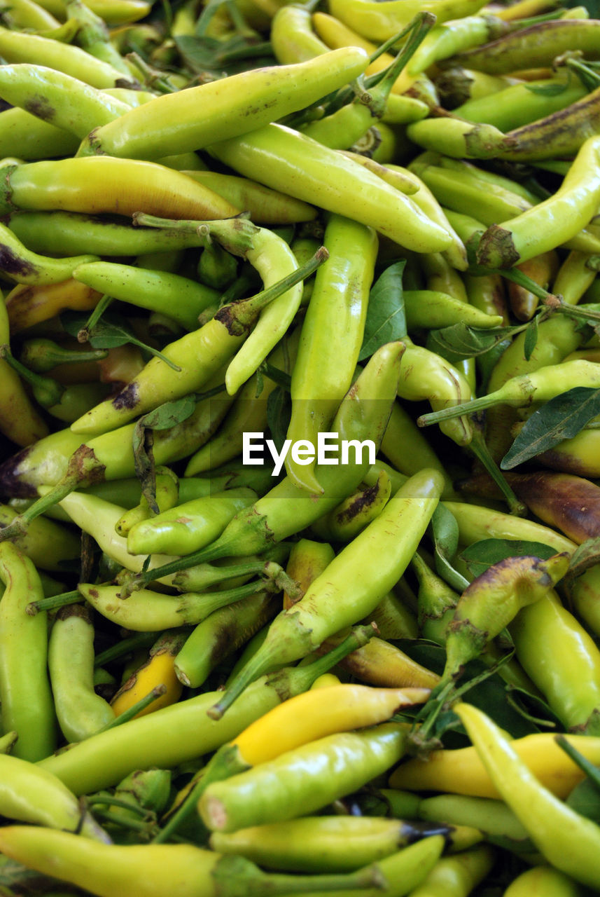 Full frame shot of green chili peppers for sale at market