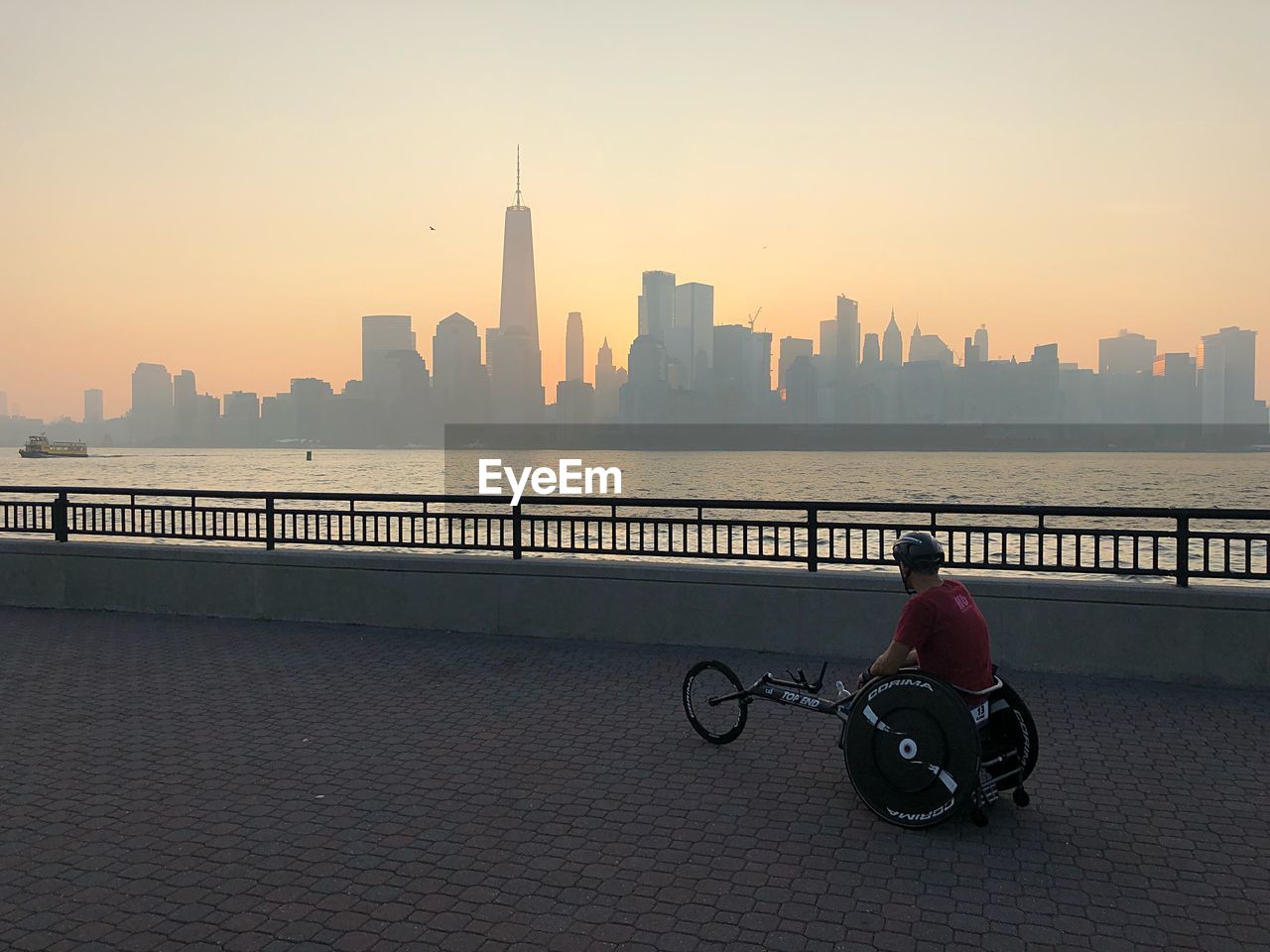 MAN RIDING MOTORCYCLE ON BUILDING IN CITY