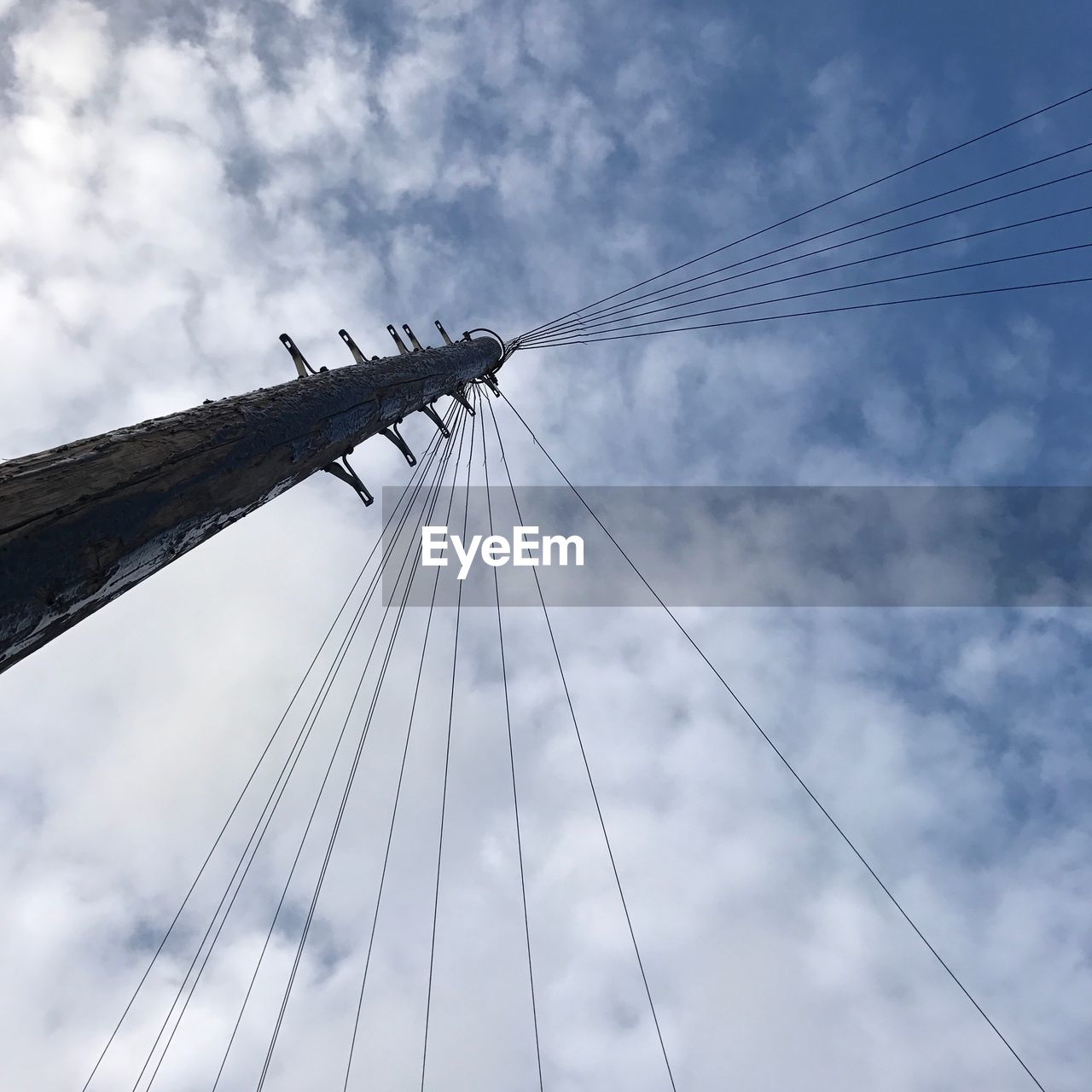 Low angle view of utility pole against sky