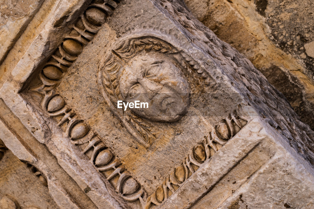 CLOSE-UP OF CARVINGS ON CROSS