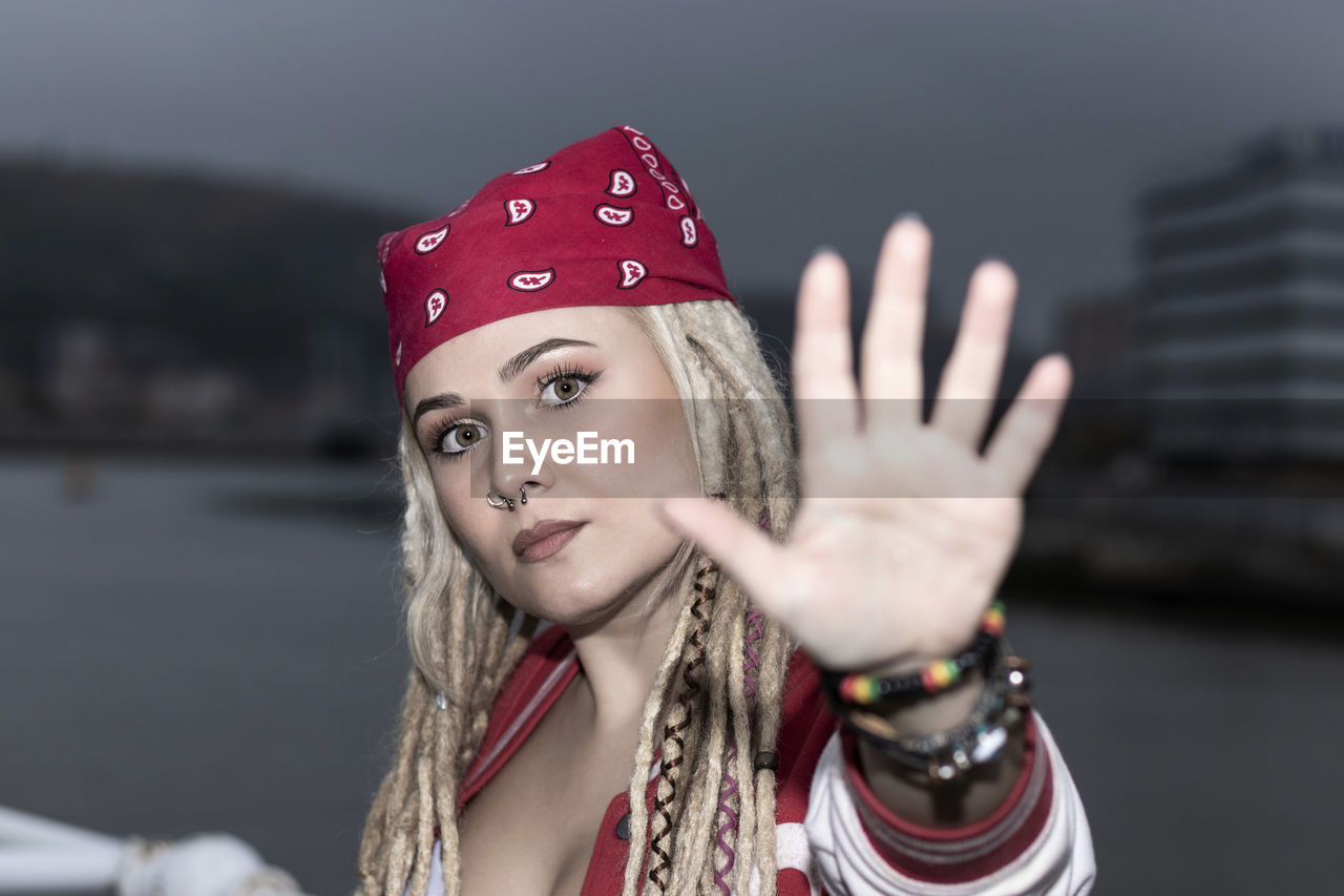 Blonde woman with dreadlocks ordering to stop