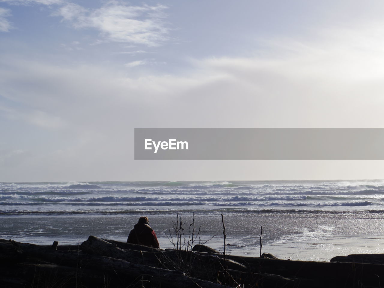 WOMAN ON BEACH AGAINST SKY