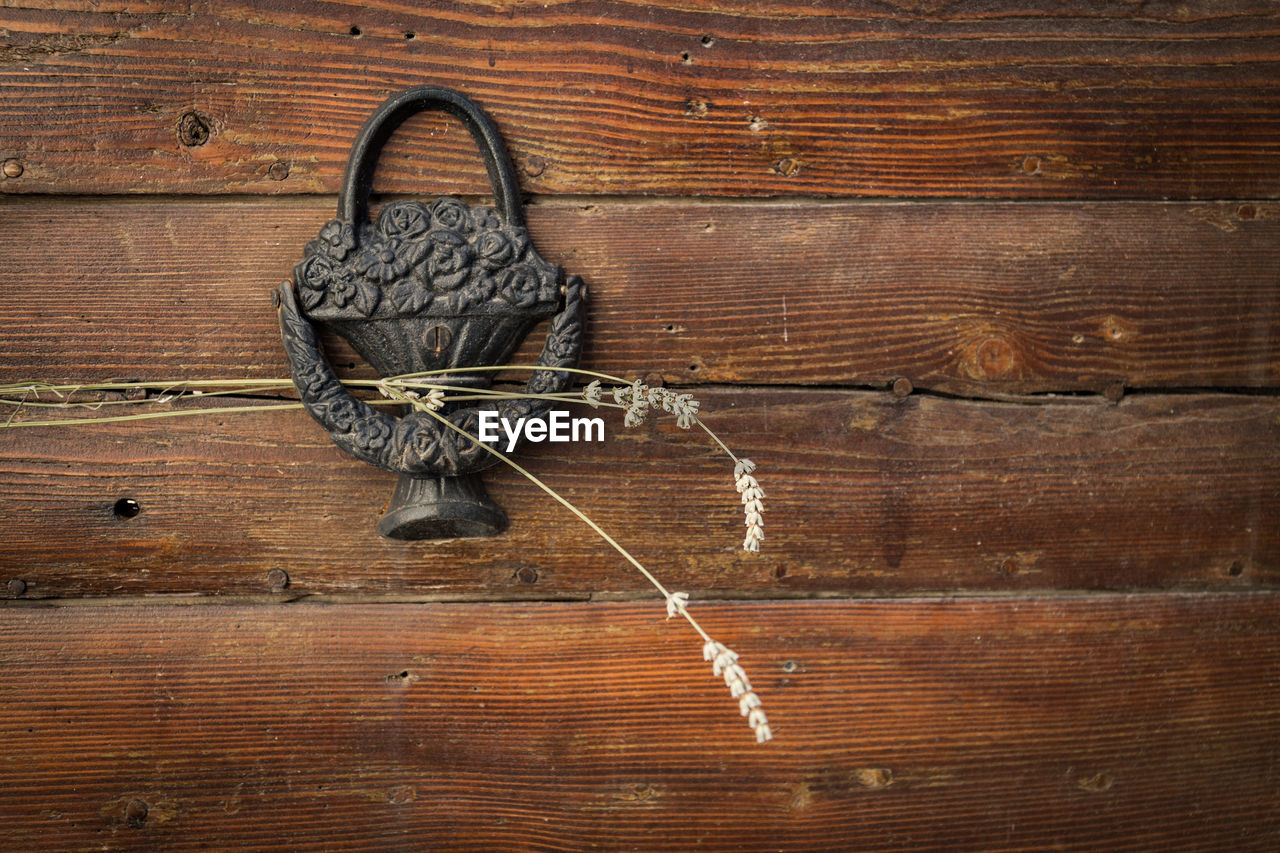 Close-up of door knocker with lavenders