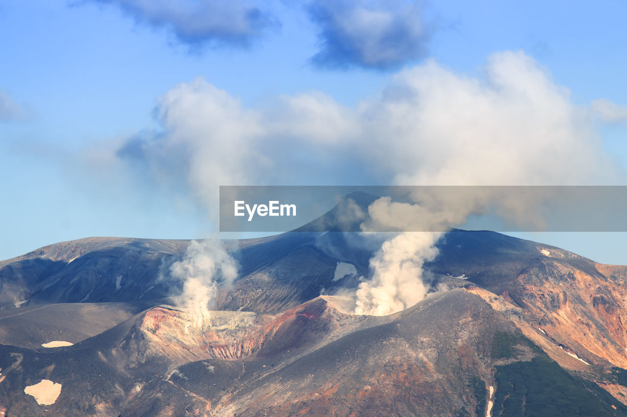 Scenic view of volcanic mountains against sky