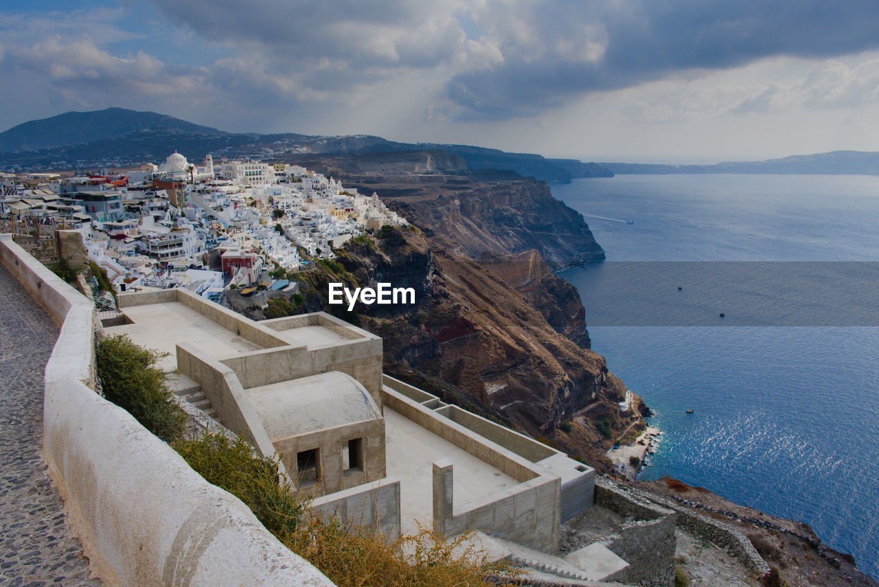 High angle view of townscape by sea against sky