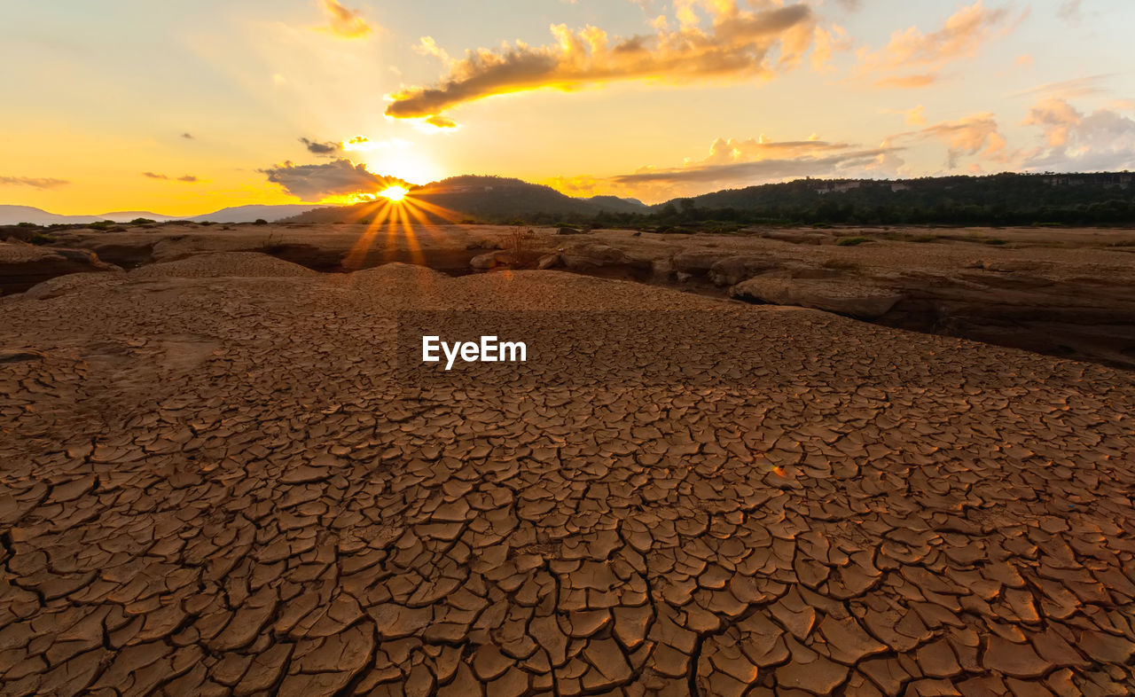 Cracked earth  at twilight at at sam pan bok in mekong river. ubonratchathani ,thailand