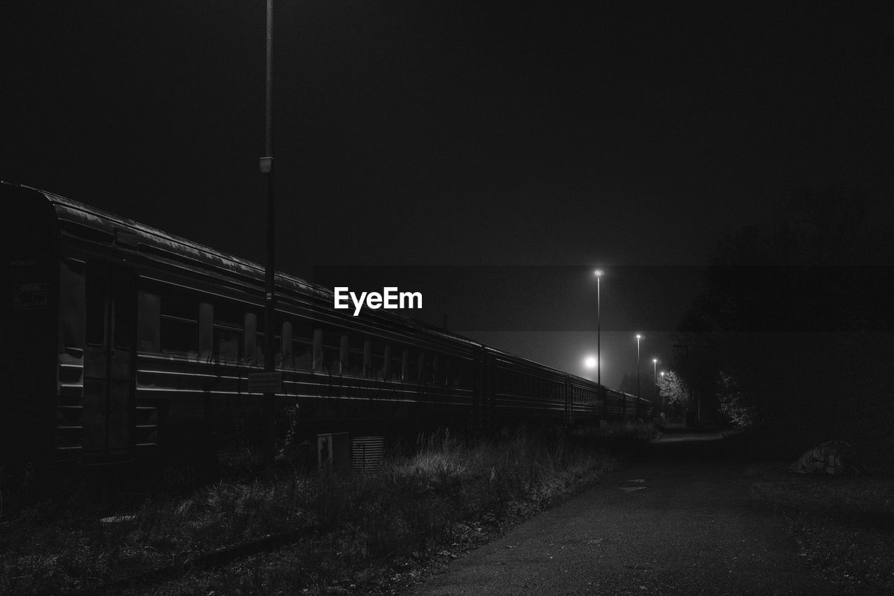 Silhouette train against sky at night