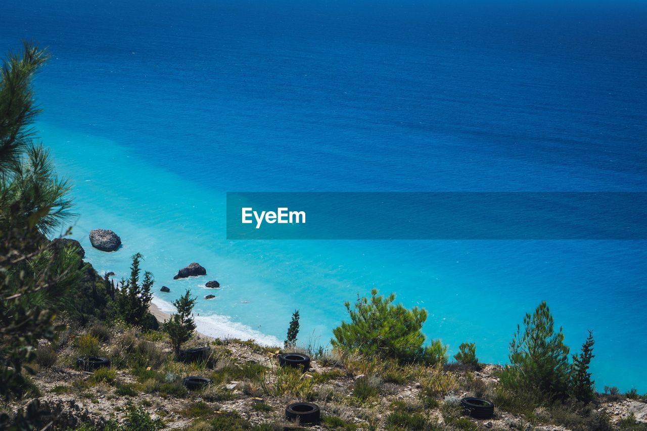 High angle view of plants and sea against blue sky