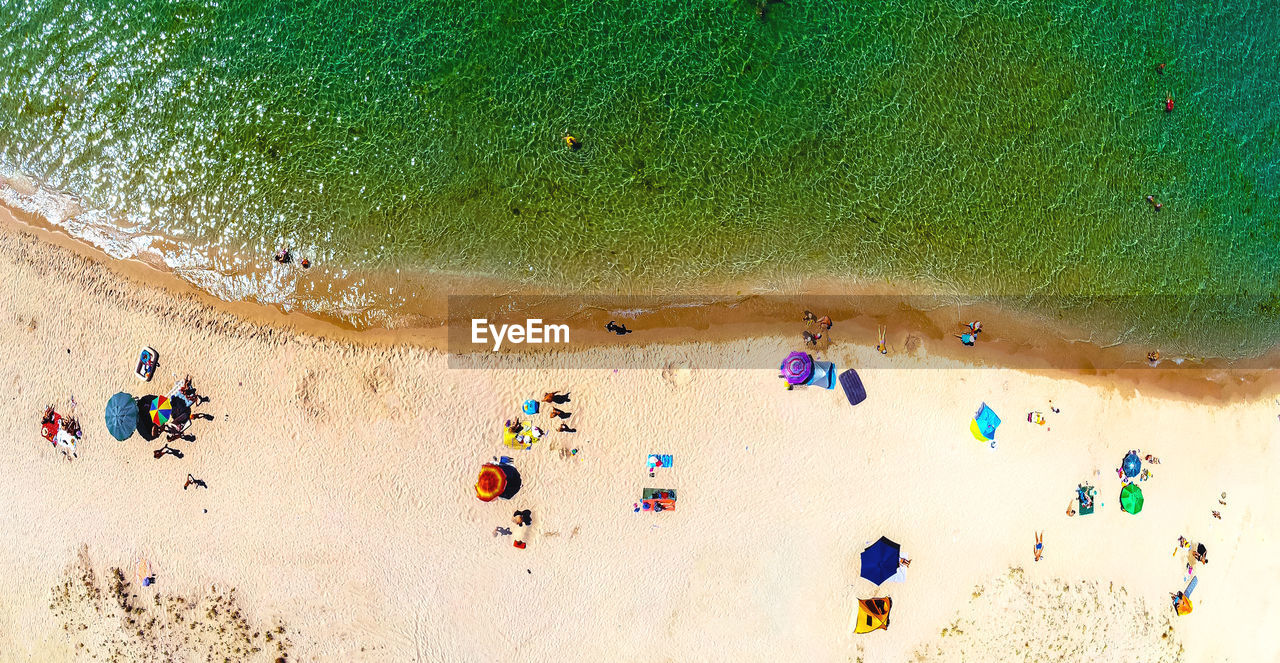 HIGH ANGLE VIEW OF PEOPLE ENJOYING AT BEACH