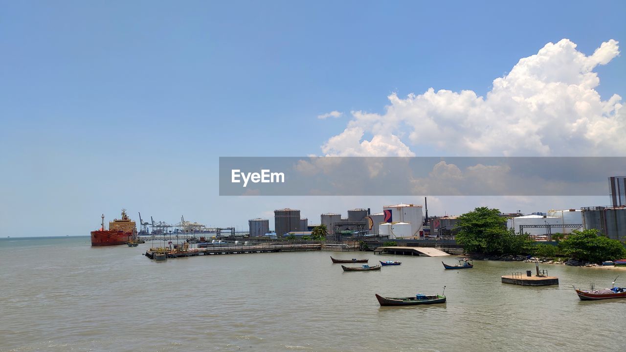 Panoramic view of sea and buildings against sky