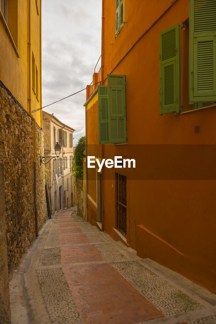 Empty alley amidst buildings in town