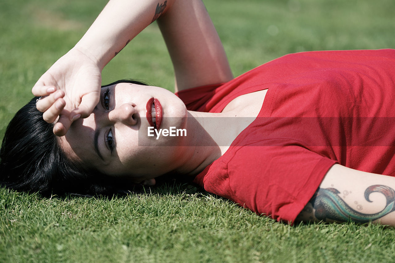 Beautiful woman lying on the grass ii