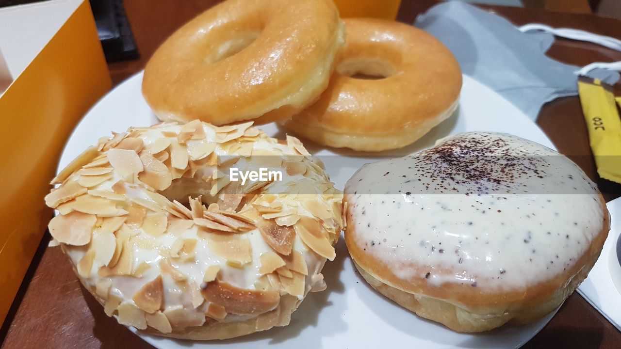 food and drink, food, doughnut, freshness, dessert, baked, bagel, sweet food, table, fast food, sweet, unhealthy eating, no people, pastry, indoors, still life, temptation, close-up, high angle view, snack, serving size, donut, meal, glaze, plate, cuisine