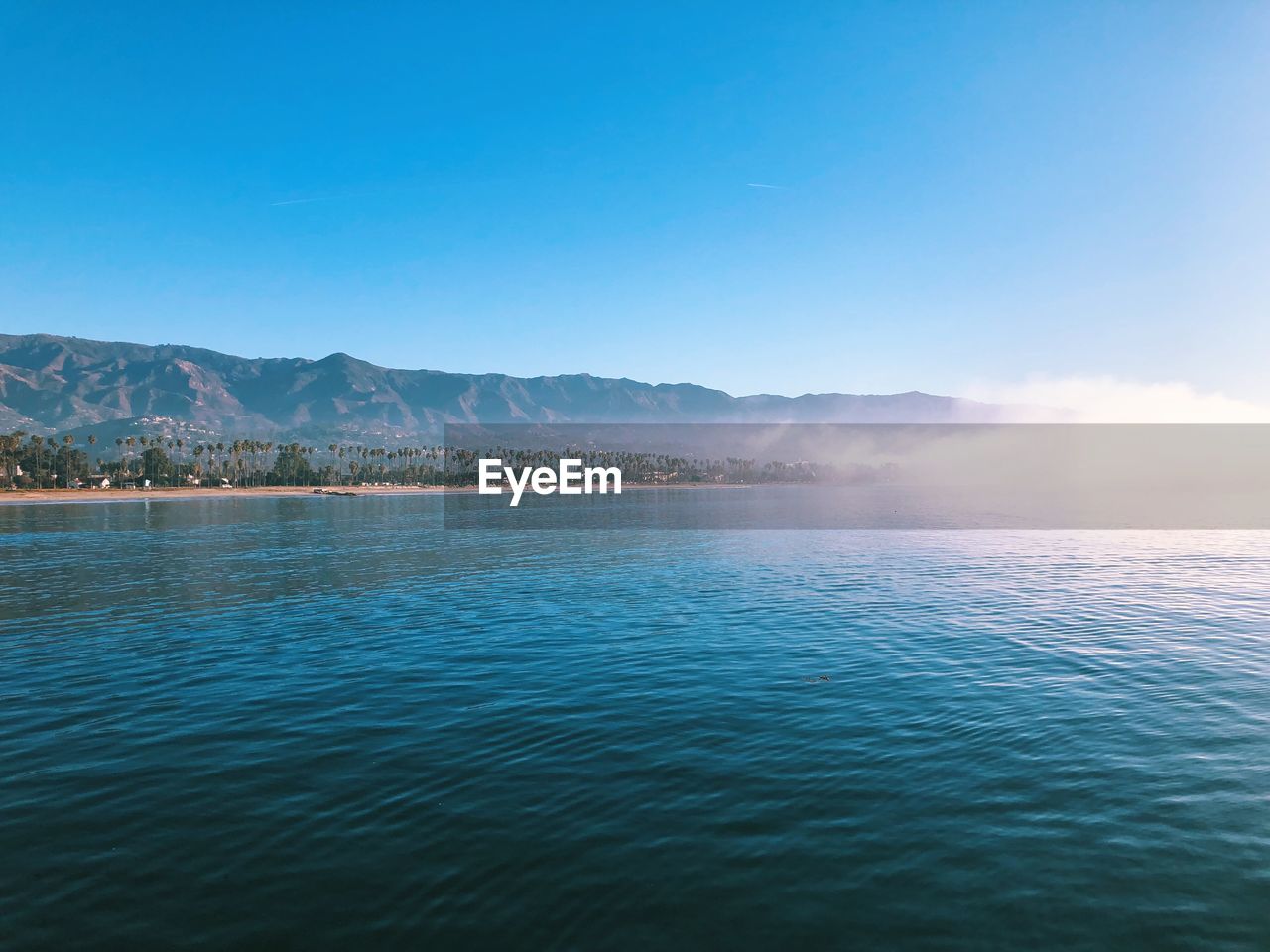 Scenic view of sea against clear blue sky