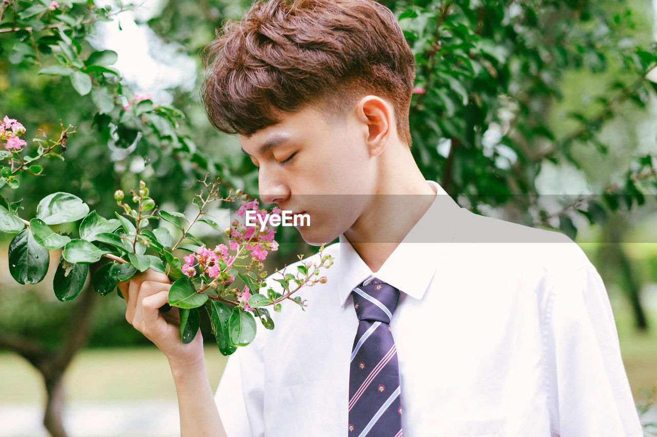 Portrait of young man against plants