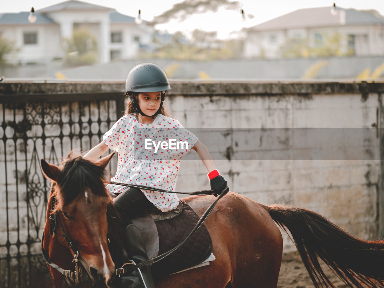 Aisan school kid riding or practicing horae at horse ranch