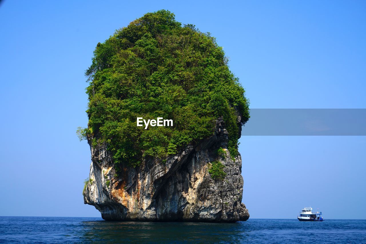 Scenic view of sea against clear blue sky