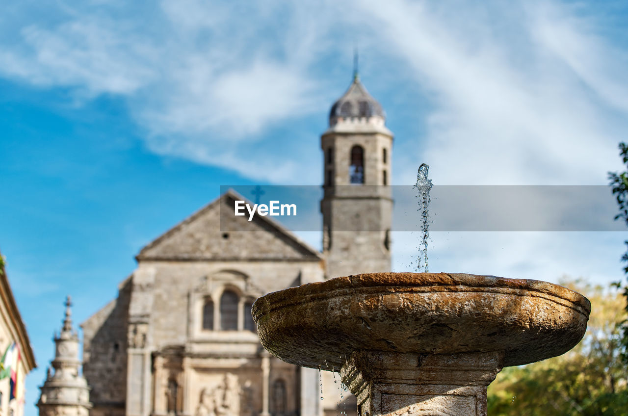 Low angle view of drinking fountain against church