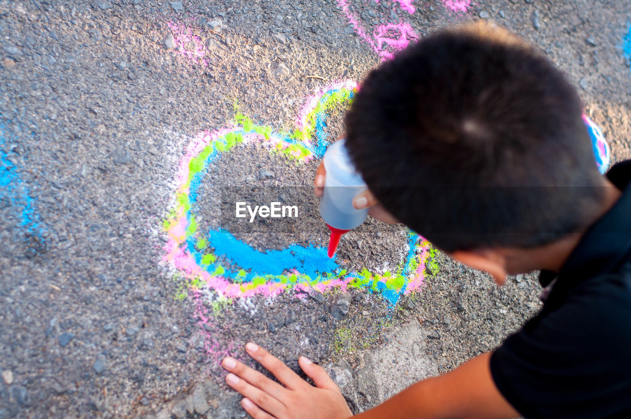 HIGH ANGLE VIEW OF CHILD ON RAINBOW