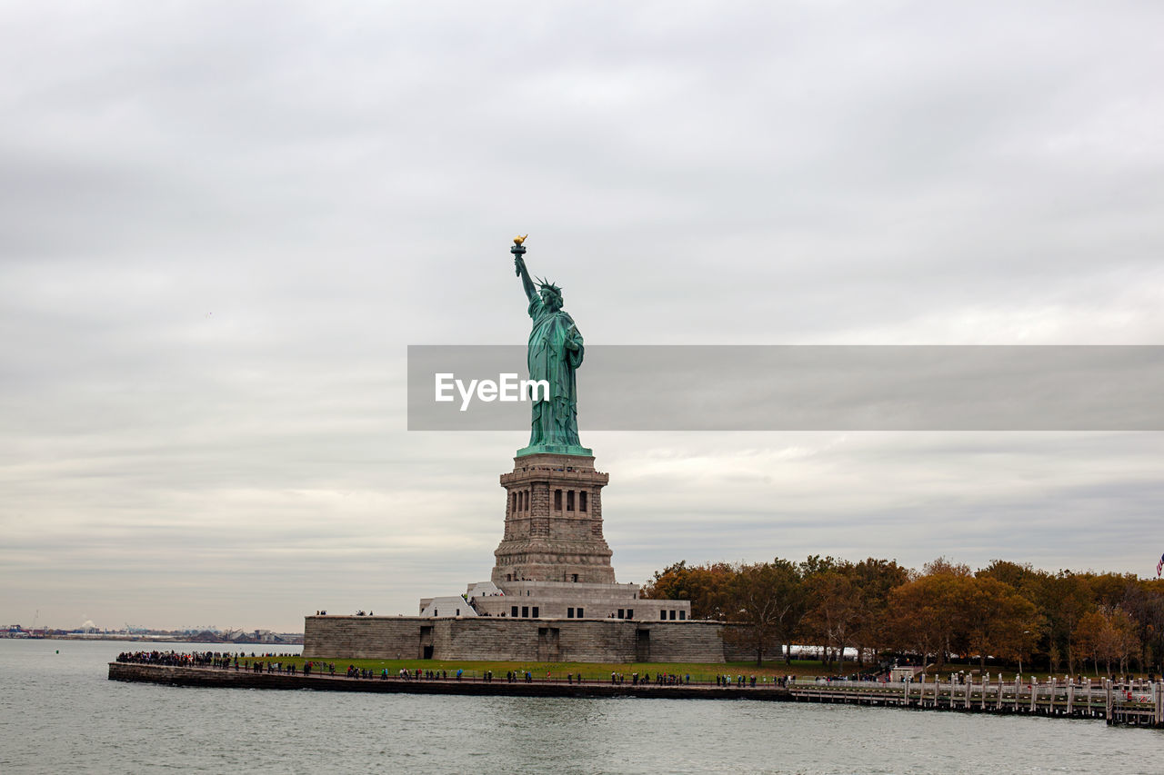 Statue of liberty against cloudy sky