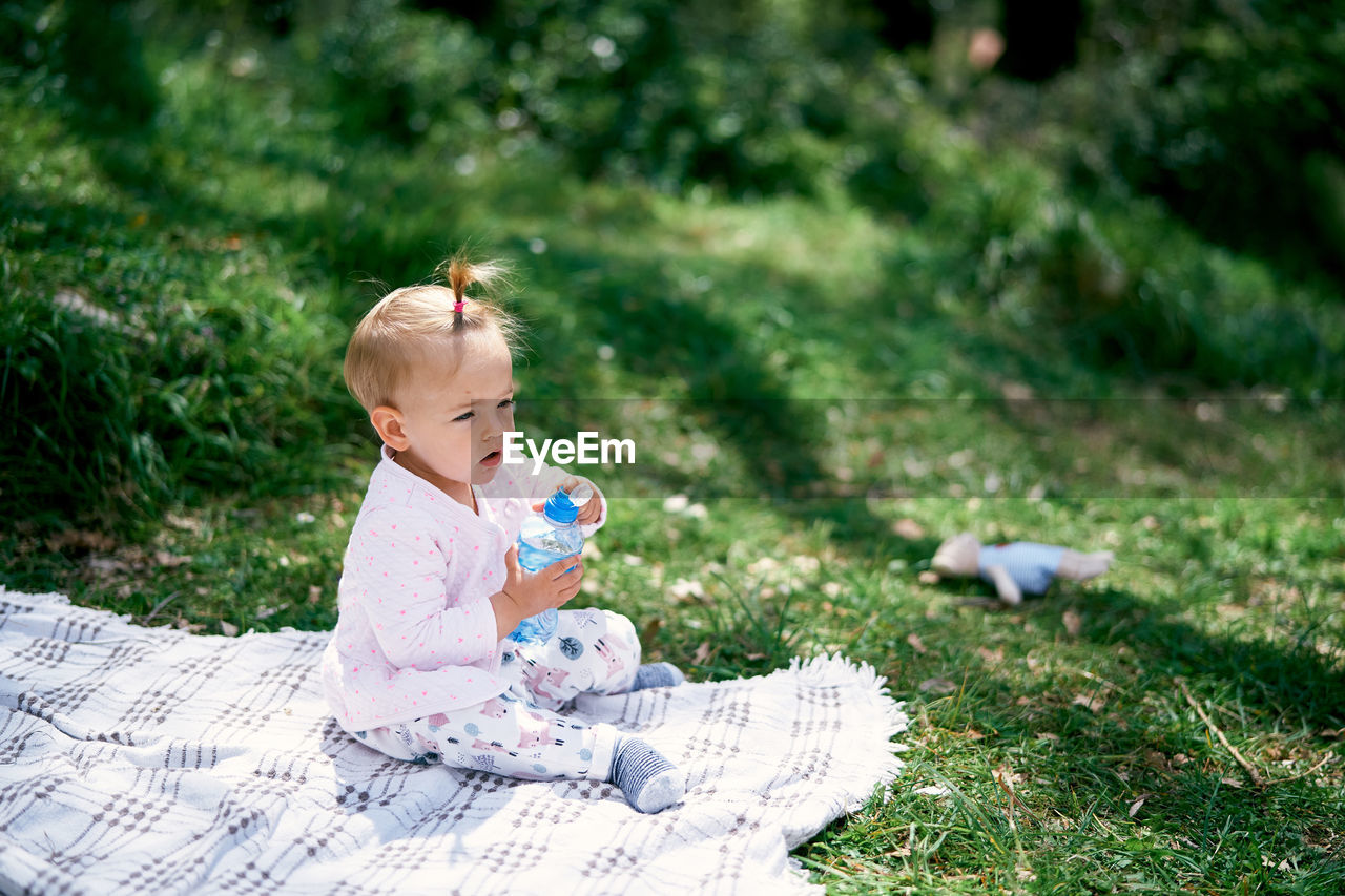 Boy sitting with toy on field