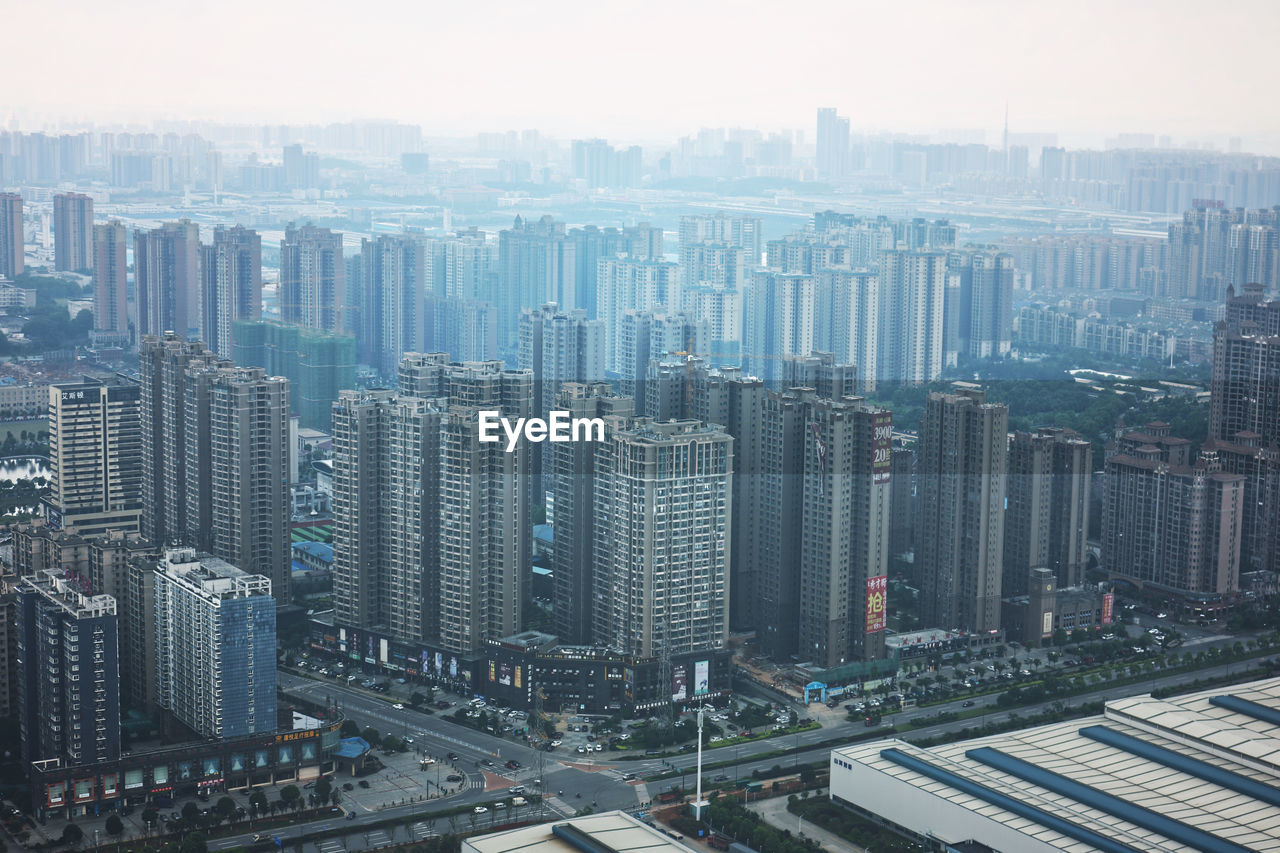 High angle view of modern buildings in city against sky