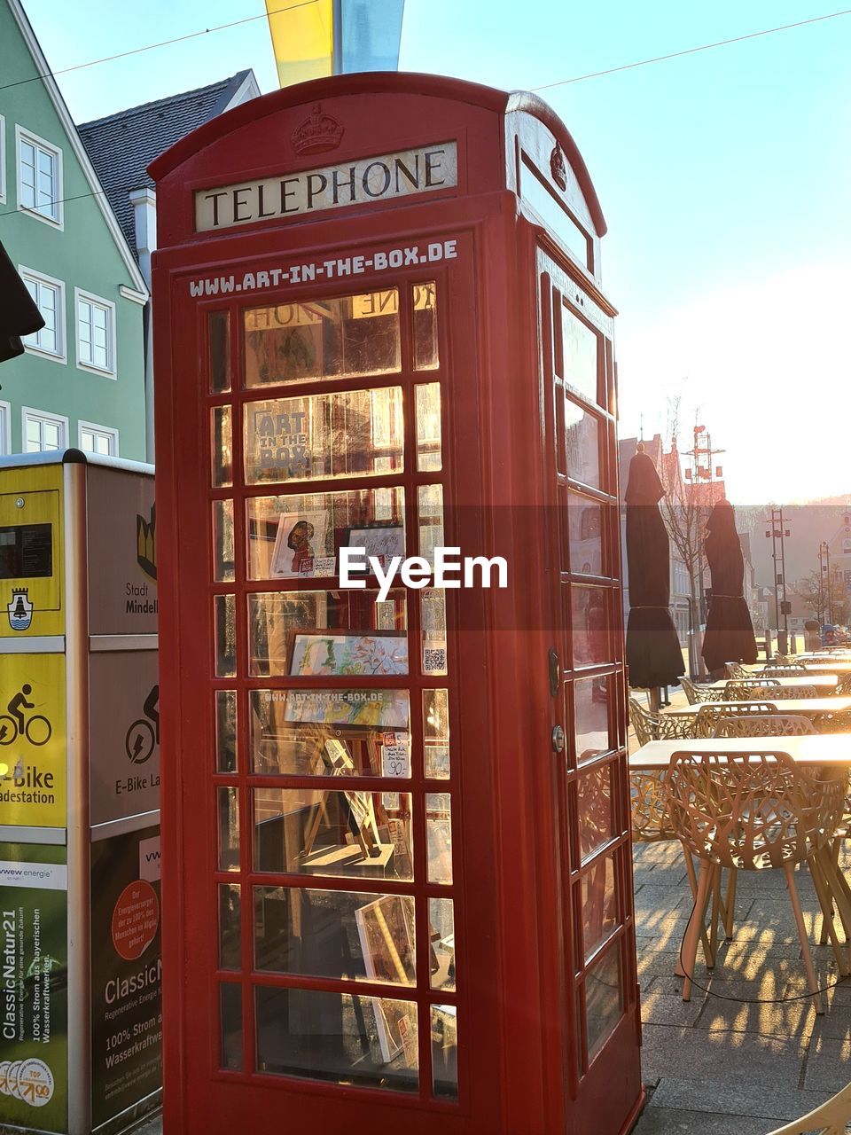 telephone booth, communication, telephone, architecture, city, outdoor structure, text, technology, sky, nature, western script, day, street, no people, building exterior, outdoors, built structure, food and drink, transportation, sunlight, red, travel destinations