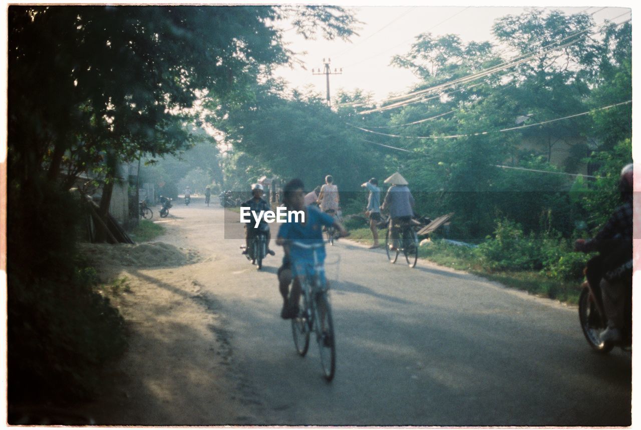 PERSON RIDING BICYCLE ON ROAD