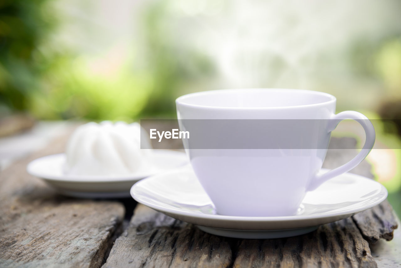 CLOSE-UP OF COFFEE ON TABLE IN PLATE