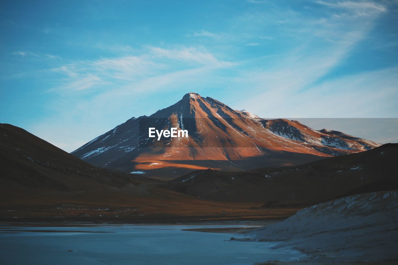 Sea with mountain in background