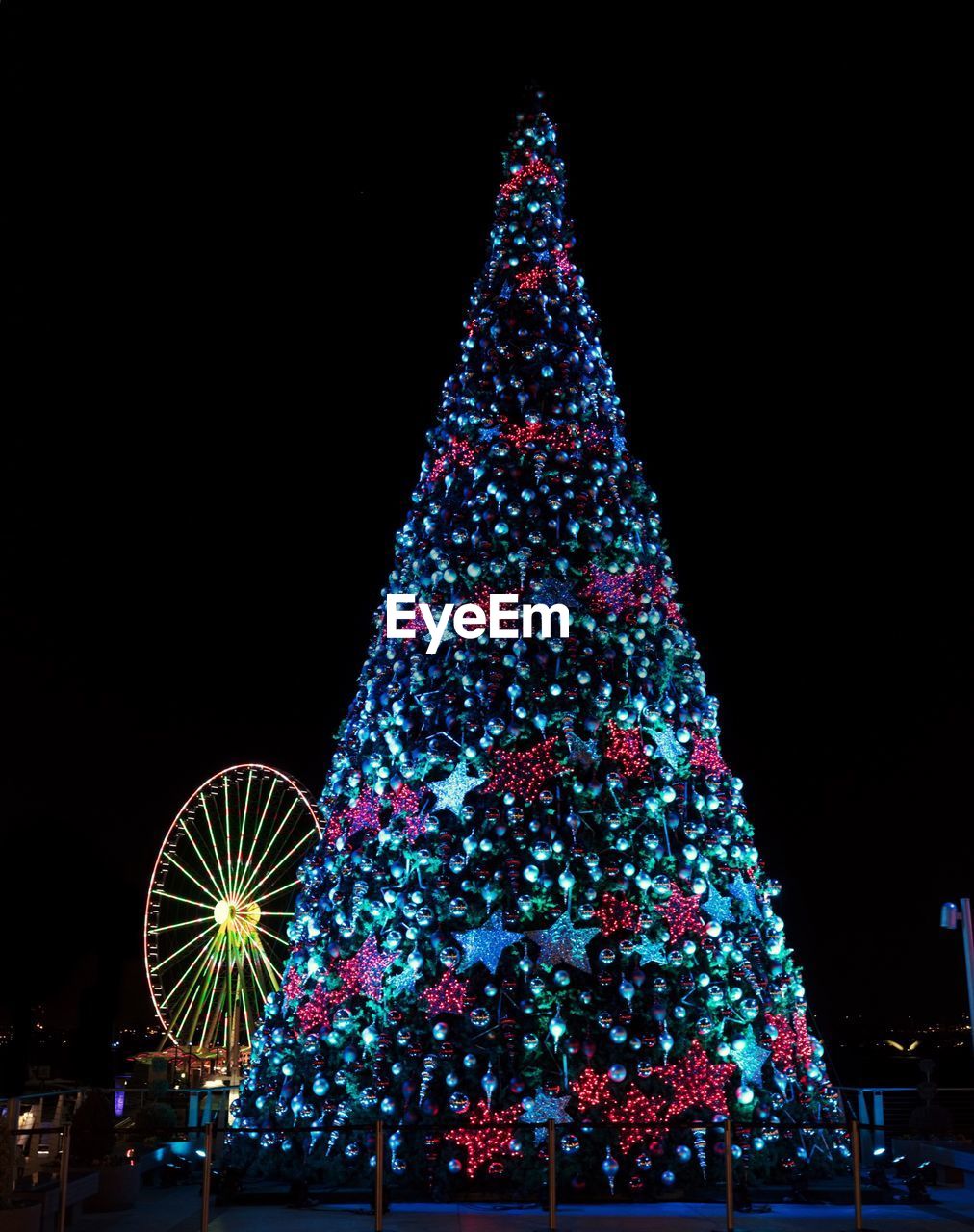 Low angle view of illuminated christmas tree at night